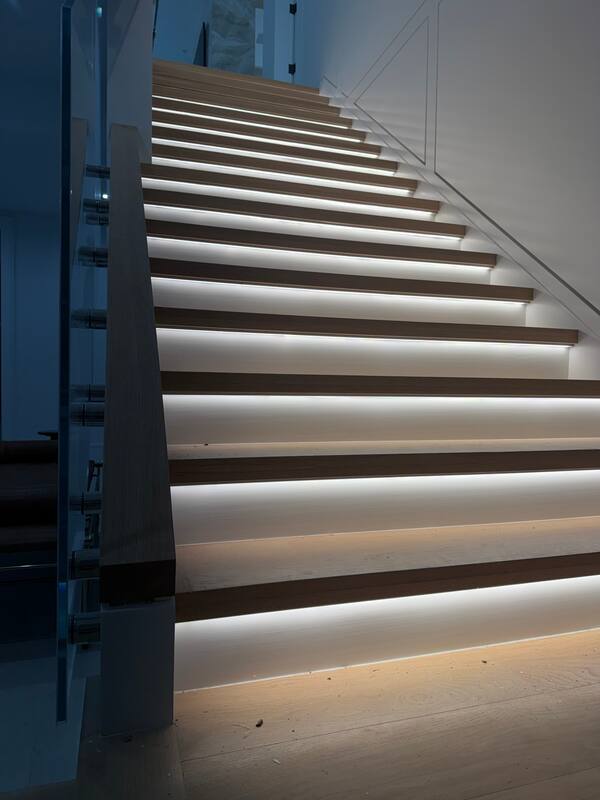 Floating wood stairs with linear LED under each tread