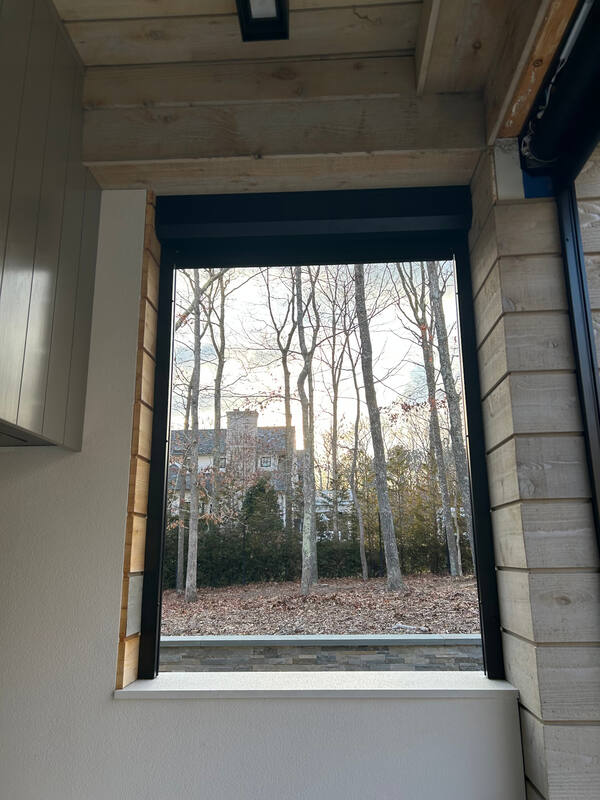 Interior window-style opening framed in black