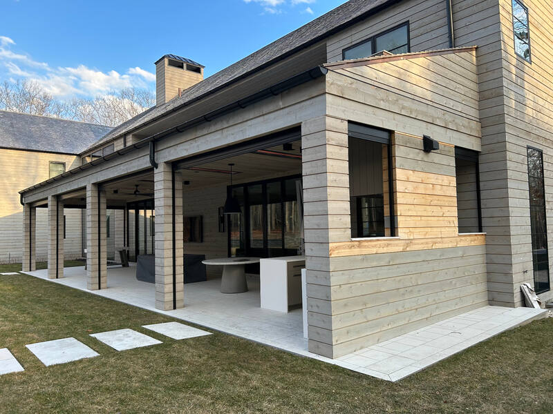 Angled view of covered patio, outdoor kitchen, and display openings
