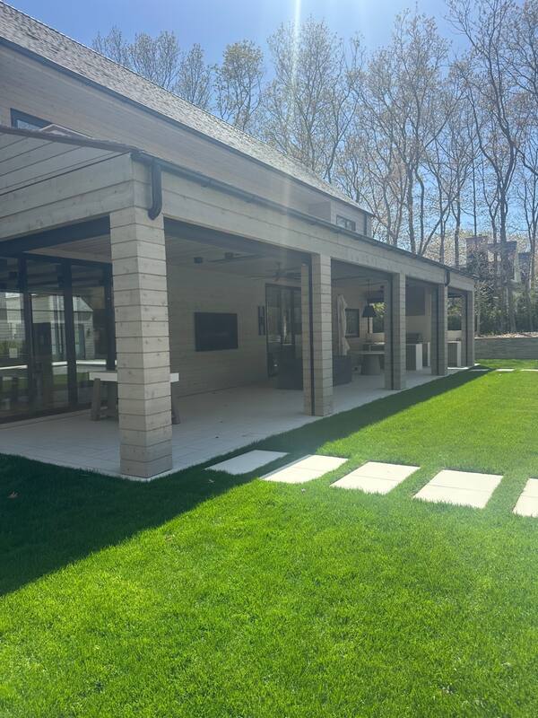 Wide lawn view with mounted outdoor television