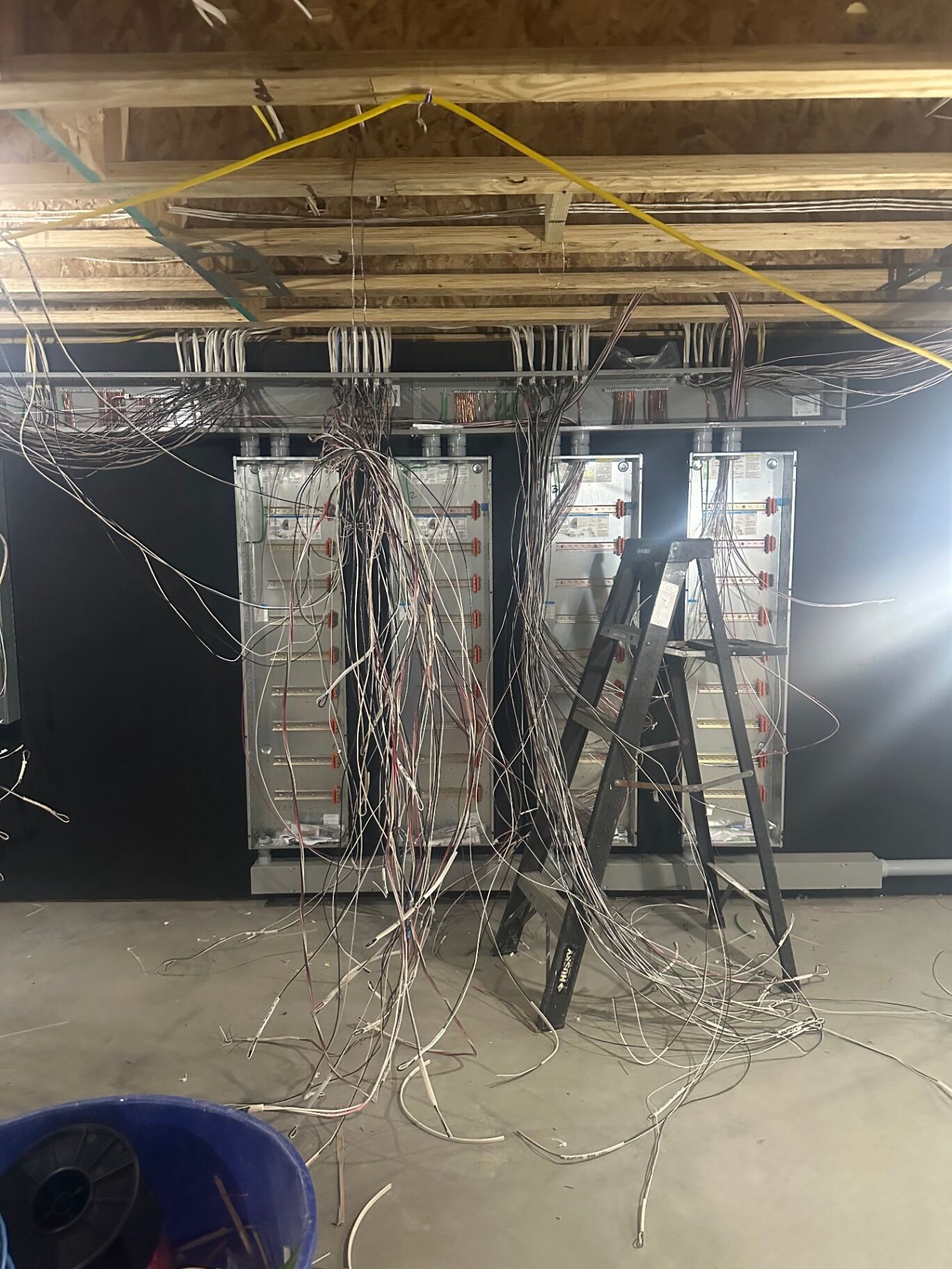 Home-run lighting cables in front of blank Lutron enclosures