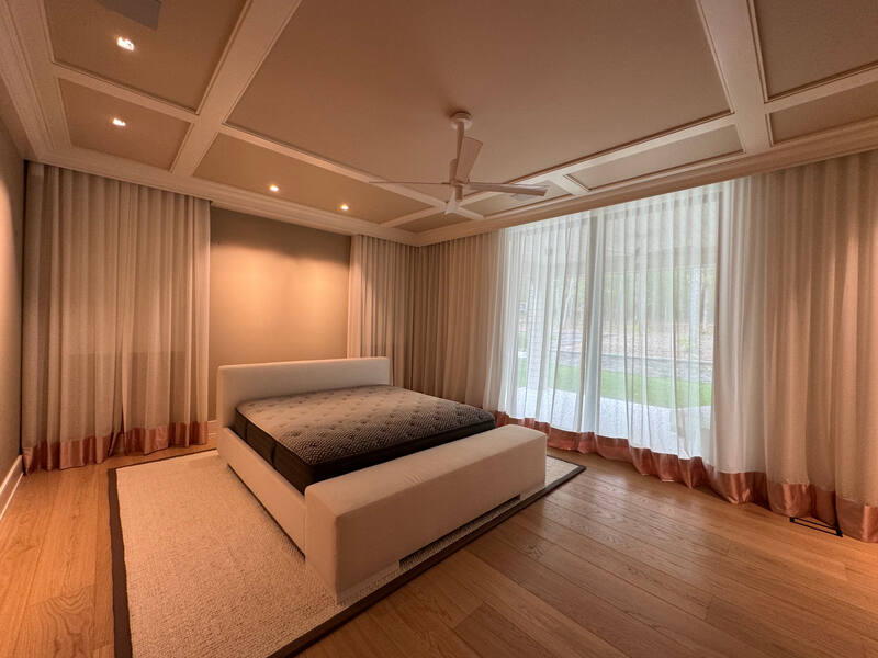 Automated drapery, coffered ceiling, and corner window wall